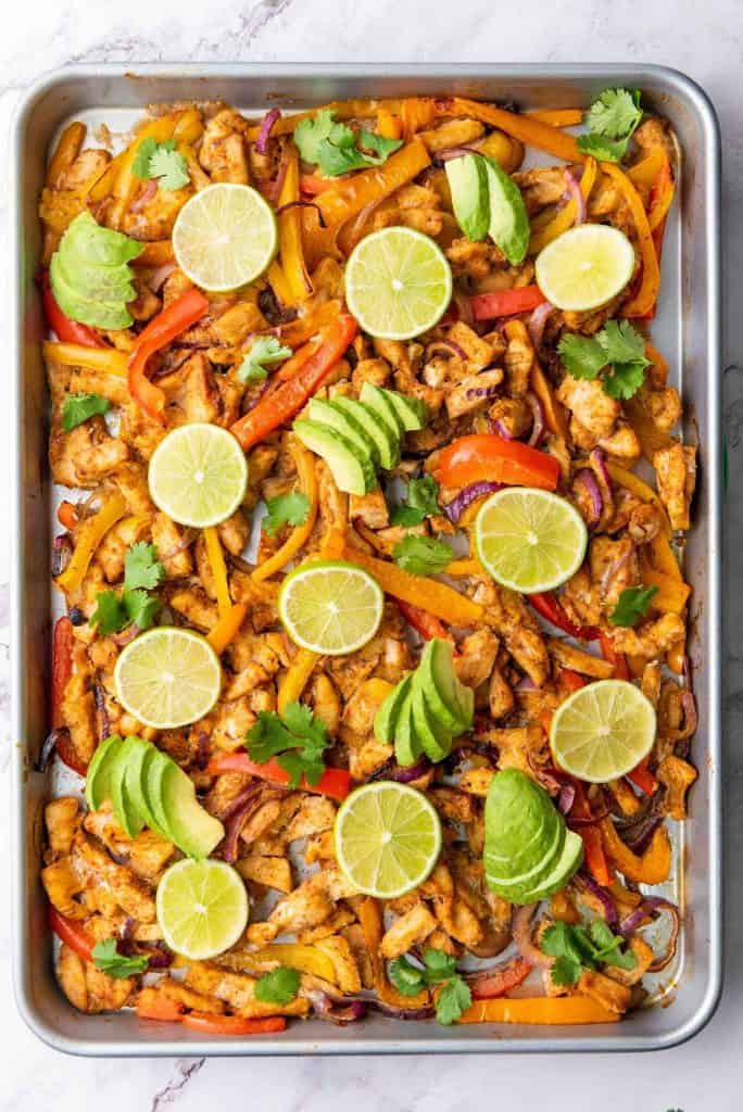 Closer look of sheet pan chicken fajitas in a serving dish.