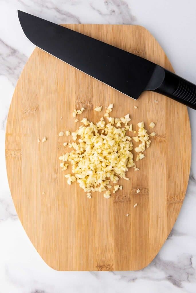 Minced the garlic on the chopping board and knife in the side.