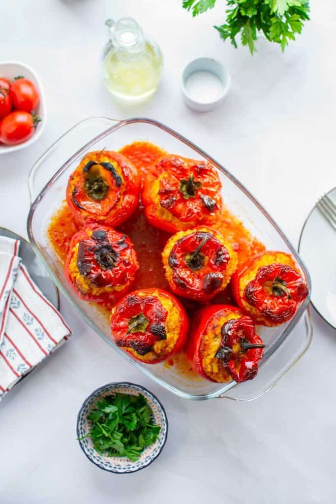 Closer look of a bunch of stuffed peppers in a serving dish.