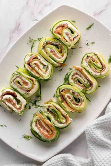 Sliced bagel cucumber rolls with smoked salmon.