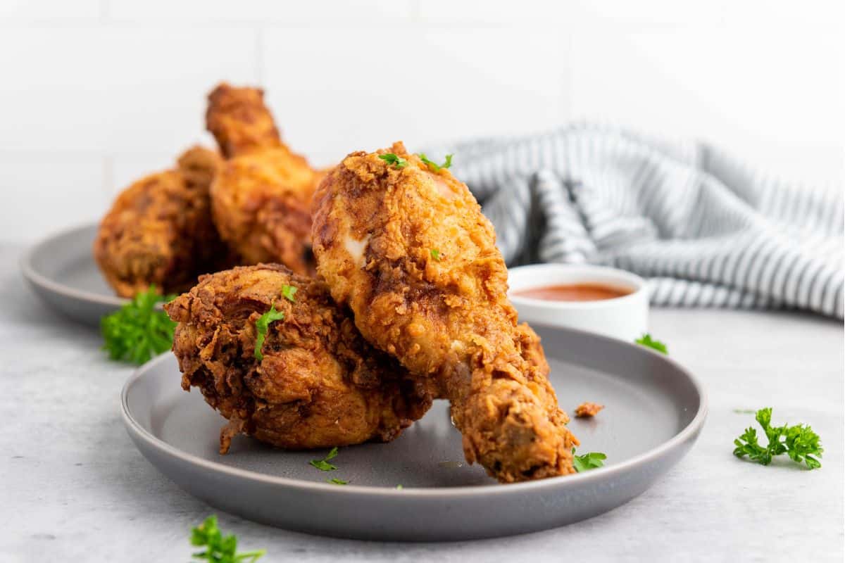Buttermilk fried chicken served on a plate, golden and crispy.