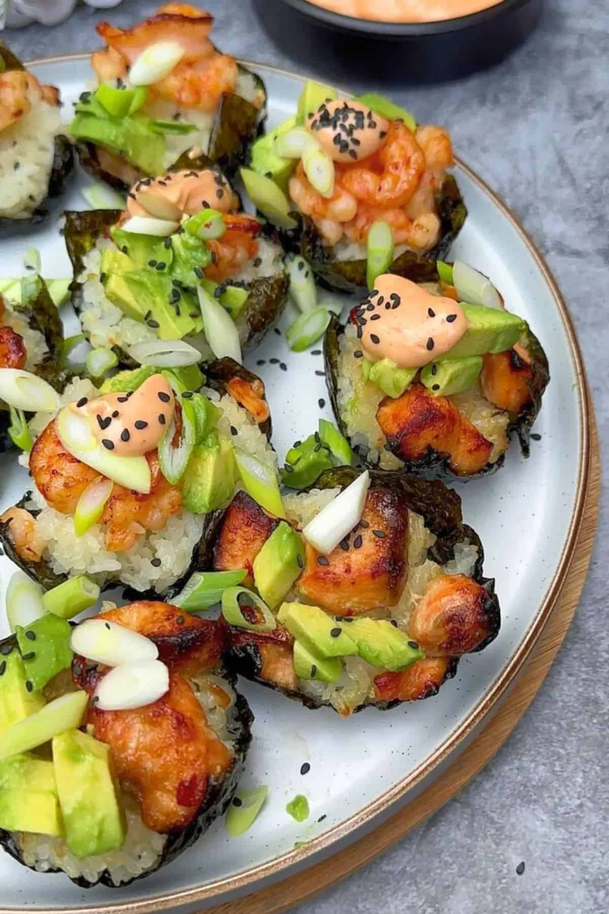 Served salmon and prawn sushi cups in a plate.