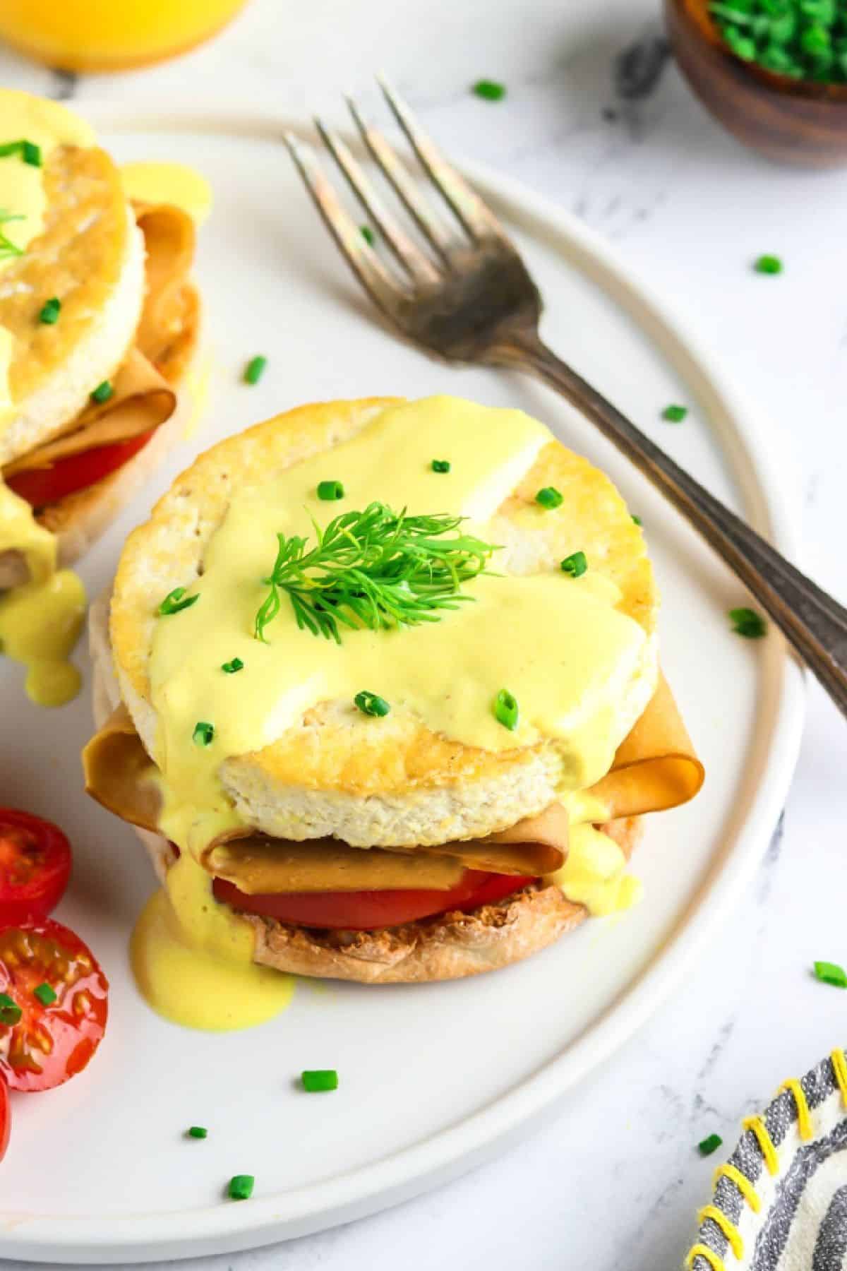 Served vegan eggs benedict with fork on the side.