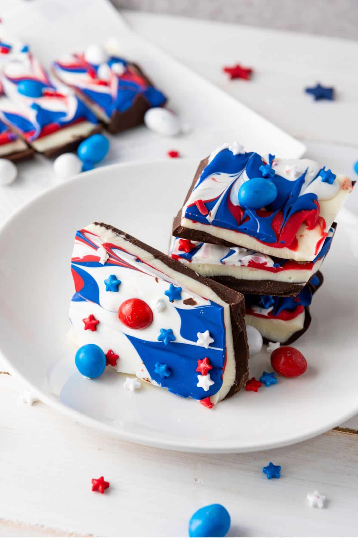 "A close-up of colorful chocolate bark, topped with red, white, and blue candies and sprinkles for a festive look.