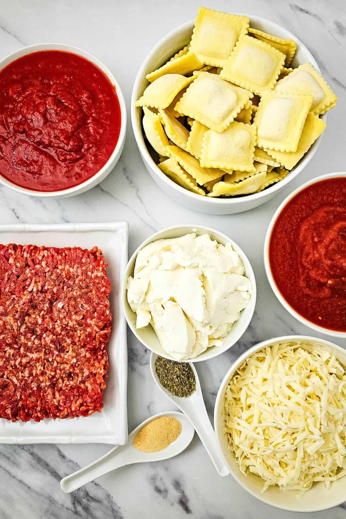 A flat lay of ingredients for crockpot lasagna arranged on a kitchen counter.