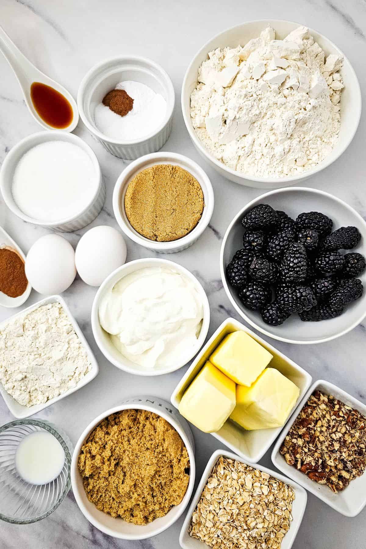 Ingredients for blueberry muffins, arranged on a surface.