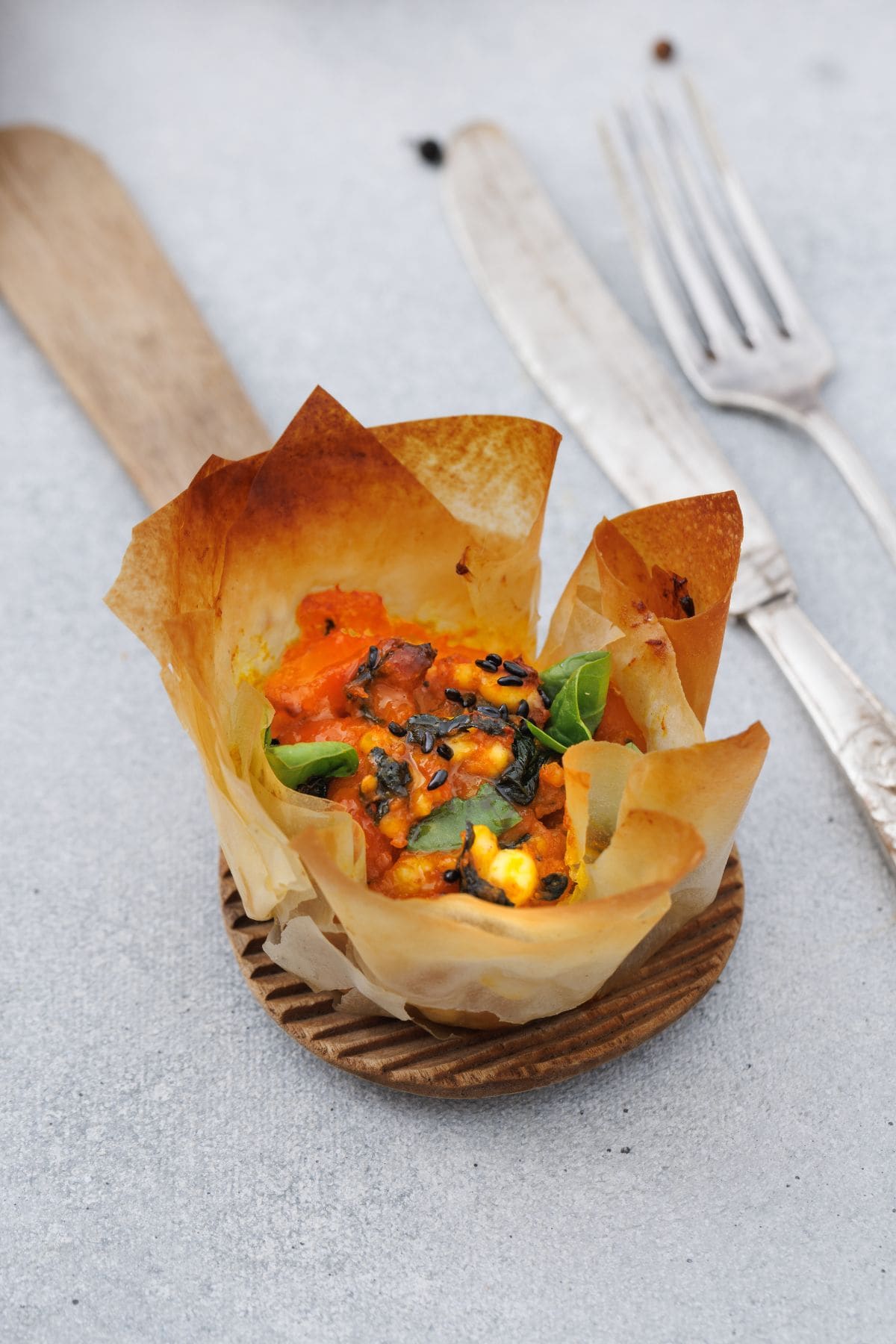 Close-up of pumpkin feta phyllo cup with fork on the side.