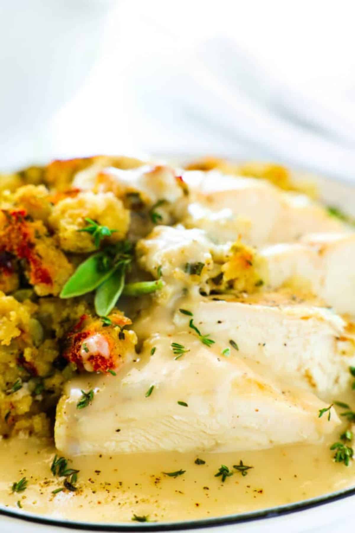 Close-up of tender chicken with stuffing, showing the moist, seasoned mix of bread and herbs.