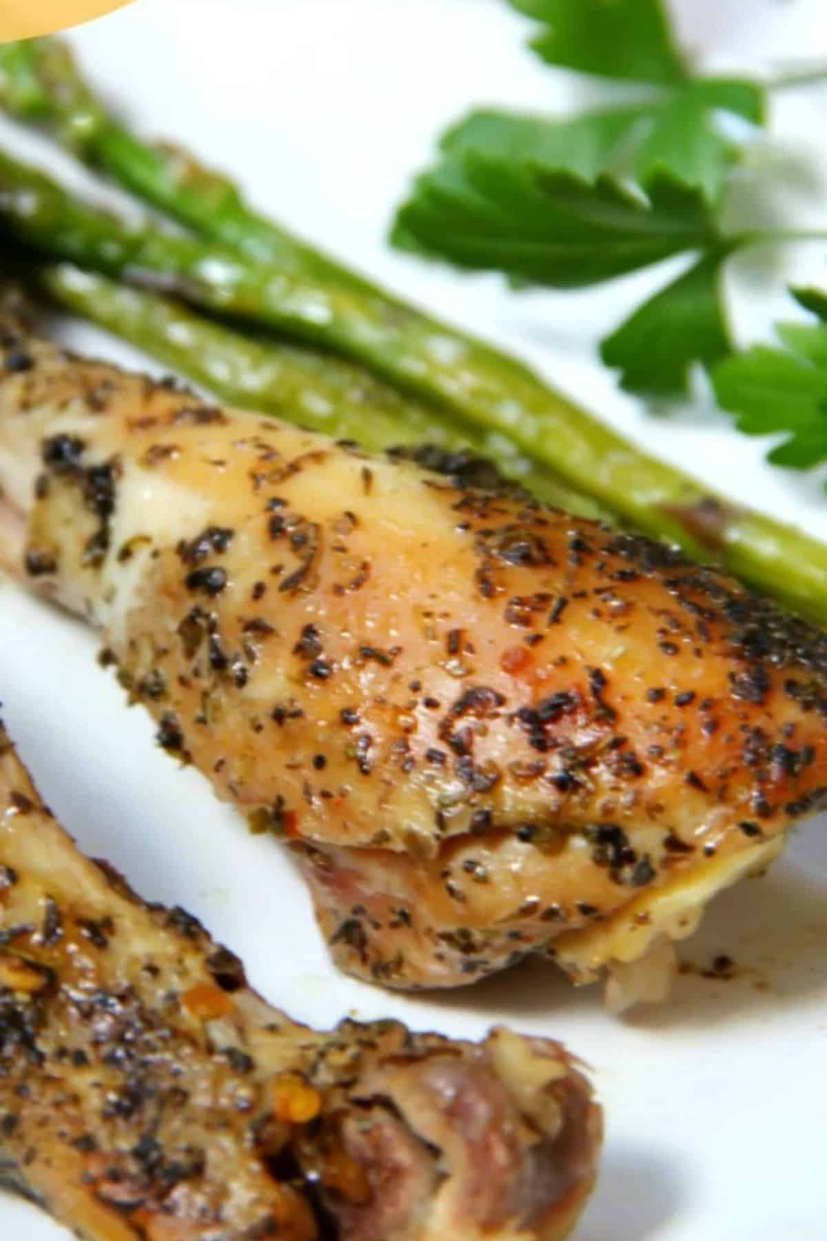 Close-up photo of a roasted chicken with fresh vegetables on the side.