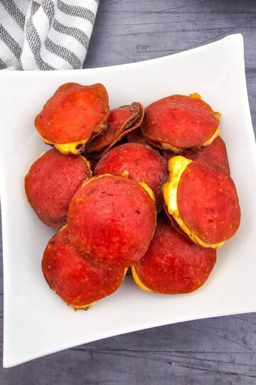 A plate stacked with cream cheese-filled pepperoni rounds.