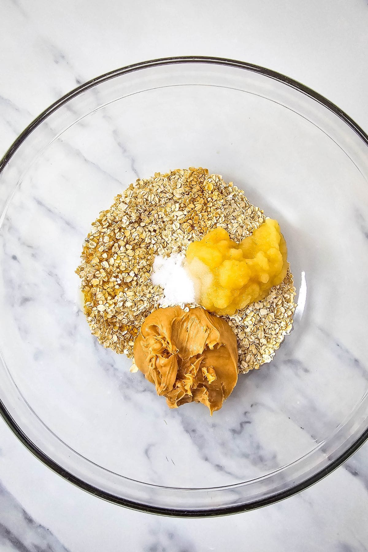 Ingredients for peanut butter oatmeal cookies in a bowl, ready to mix.