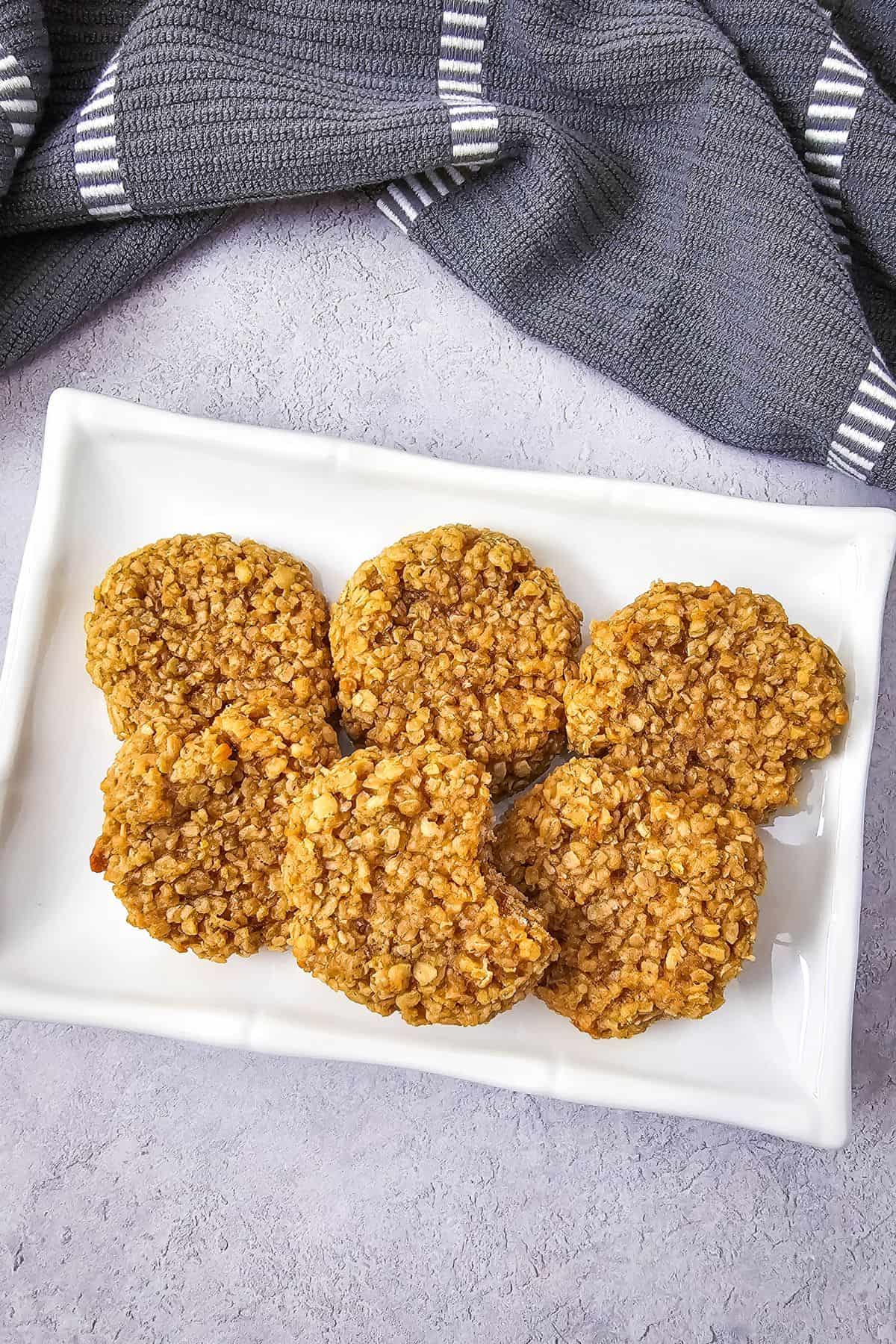 A plate of soft and chewy peanut butter oatmeal cookies, neatly arranged.