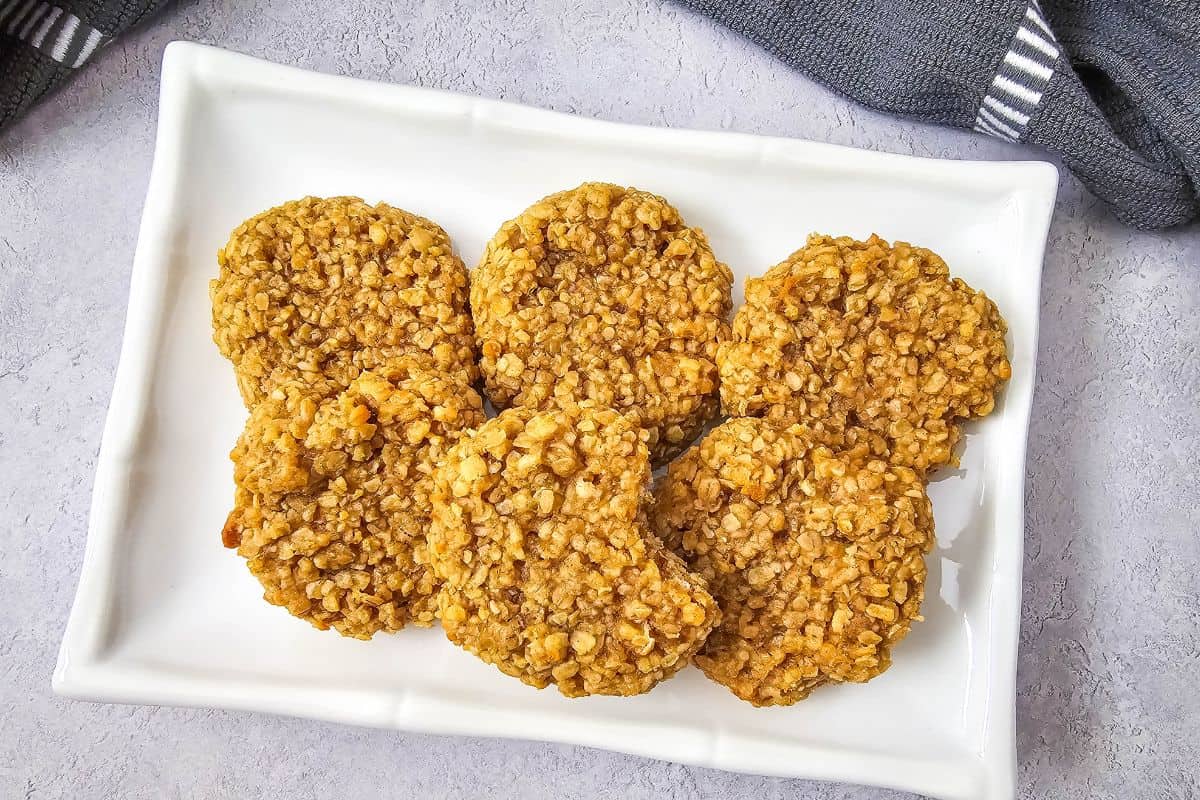 A plate of soft and chewy peanut butter oatmeal cookies, neatly arranged.
