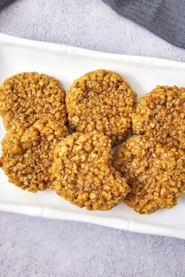 A plate of soft and chewy peanut butter oatmeal cookies, neatly arranged.