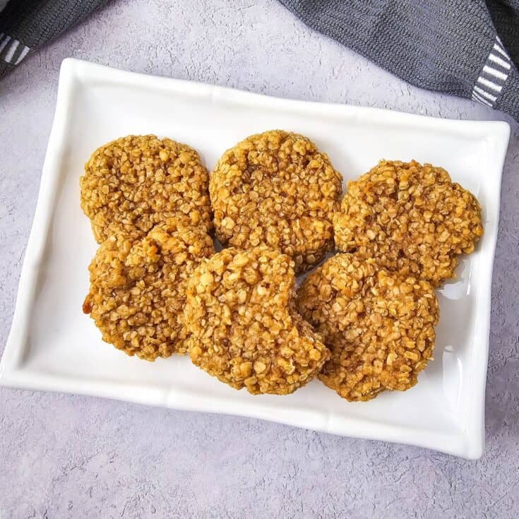 A plate of soft and chewy peanut butter oatmeal cookies, neatly arranged.