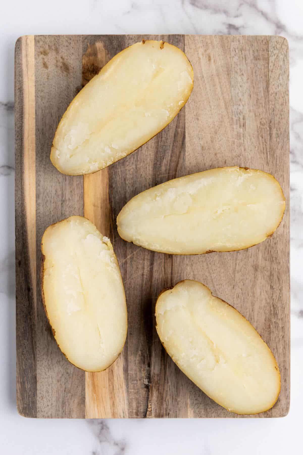A baked potatoes sliced in half.