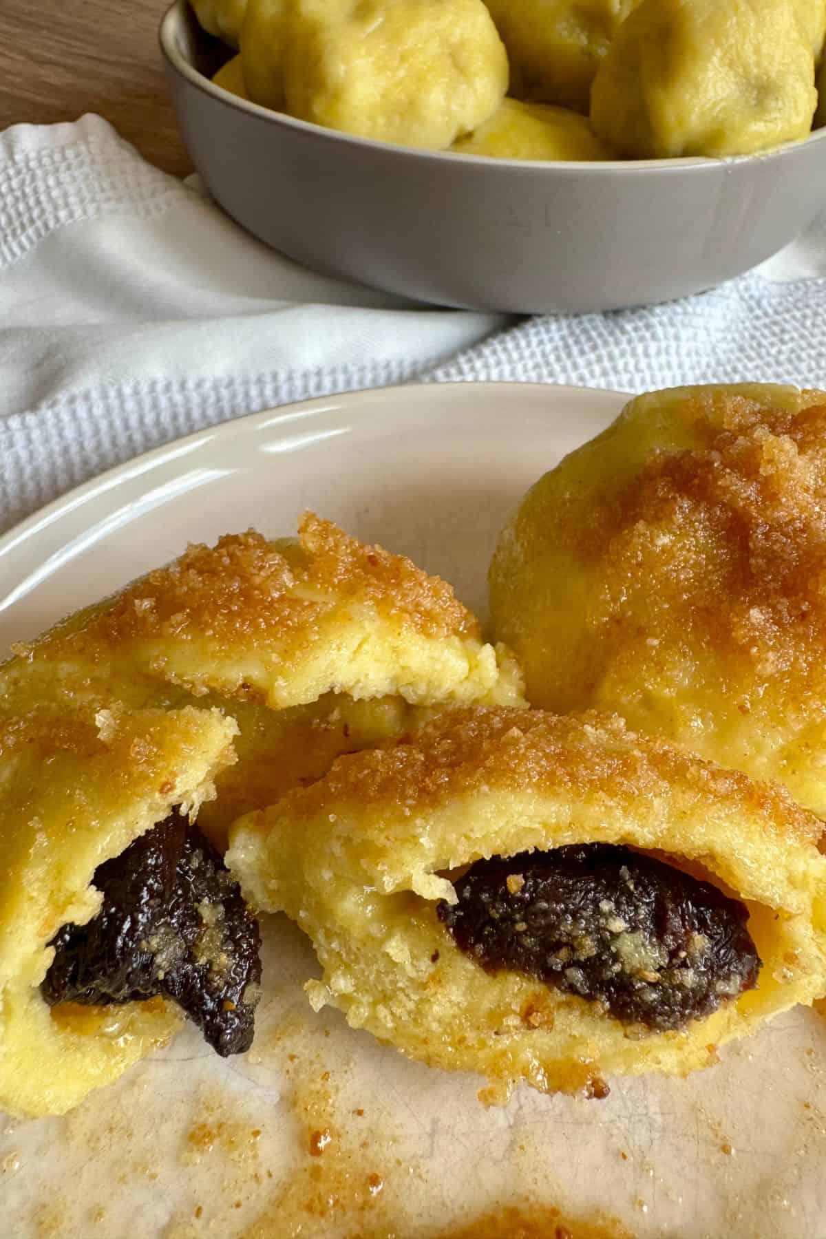 Slovenian potato plum dumplings showing their soft, smooth outer surface.