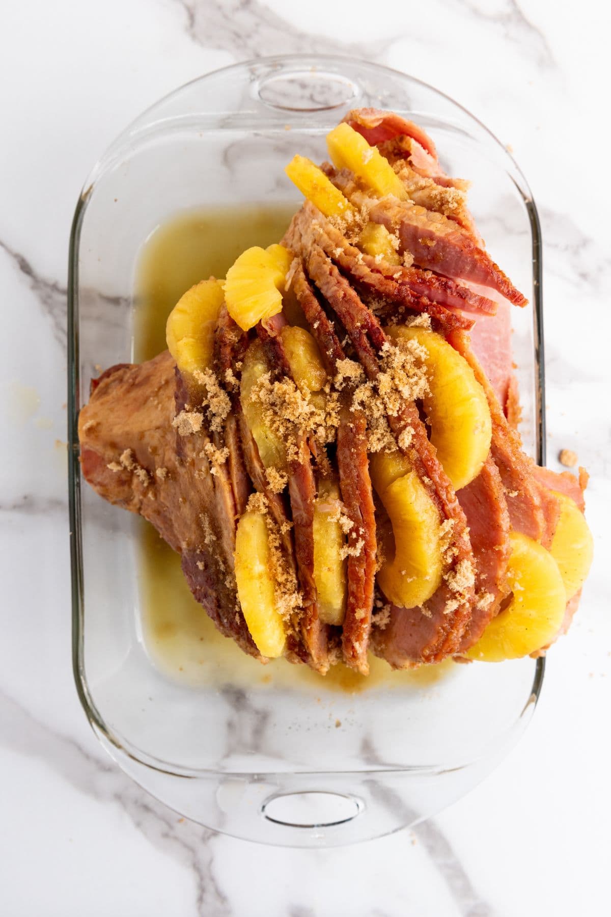 Slices of ham with pineapple on top, soaked in sweet pineapple juice and brown sugar.