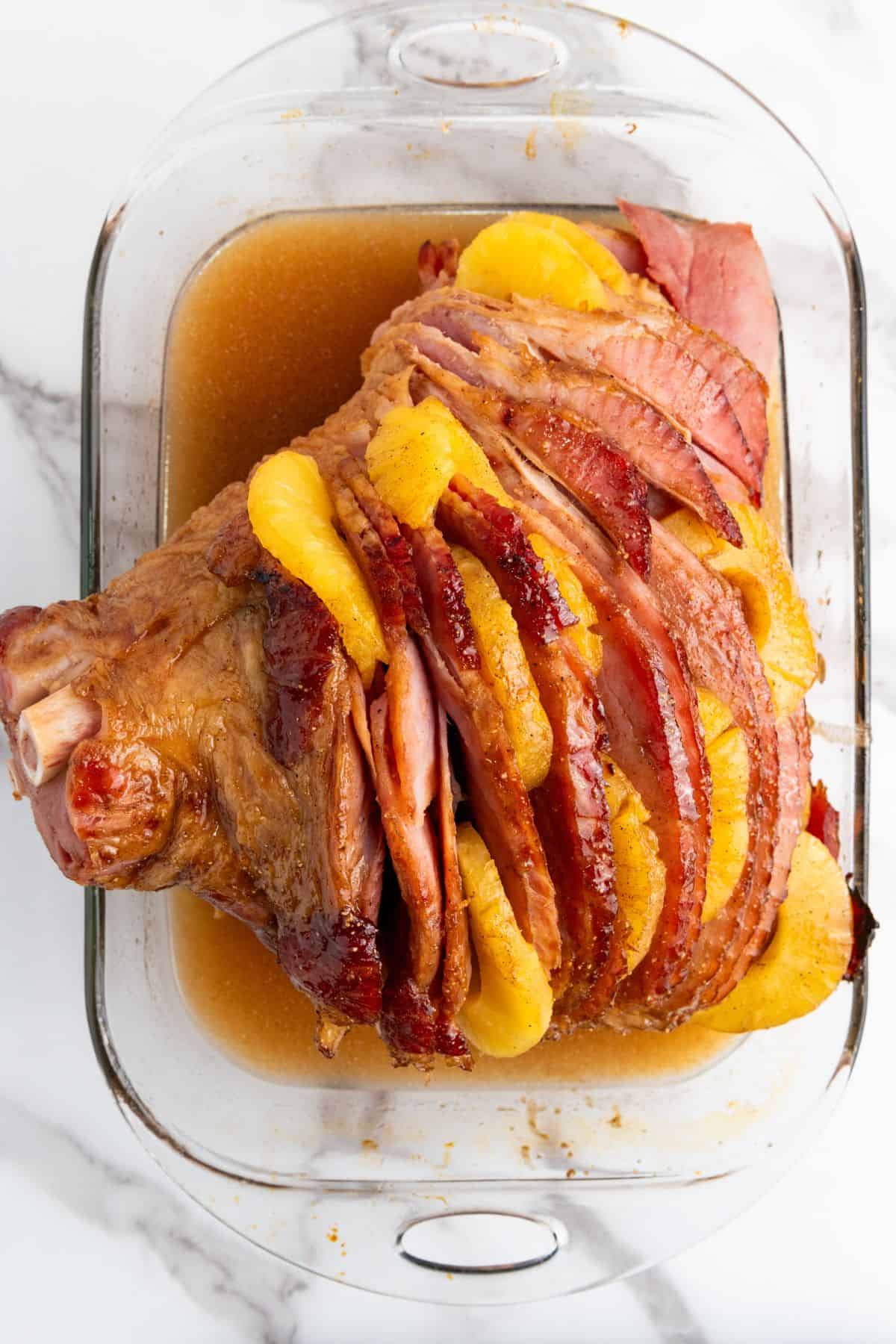 Slices of ham with pineapple on top, soaked in sweet pineapple juice and brown sugar glaze.