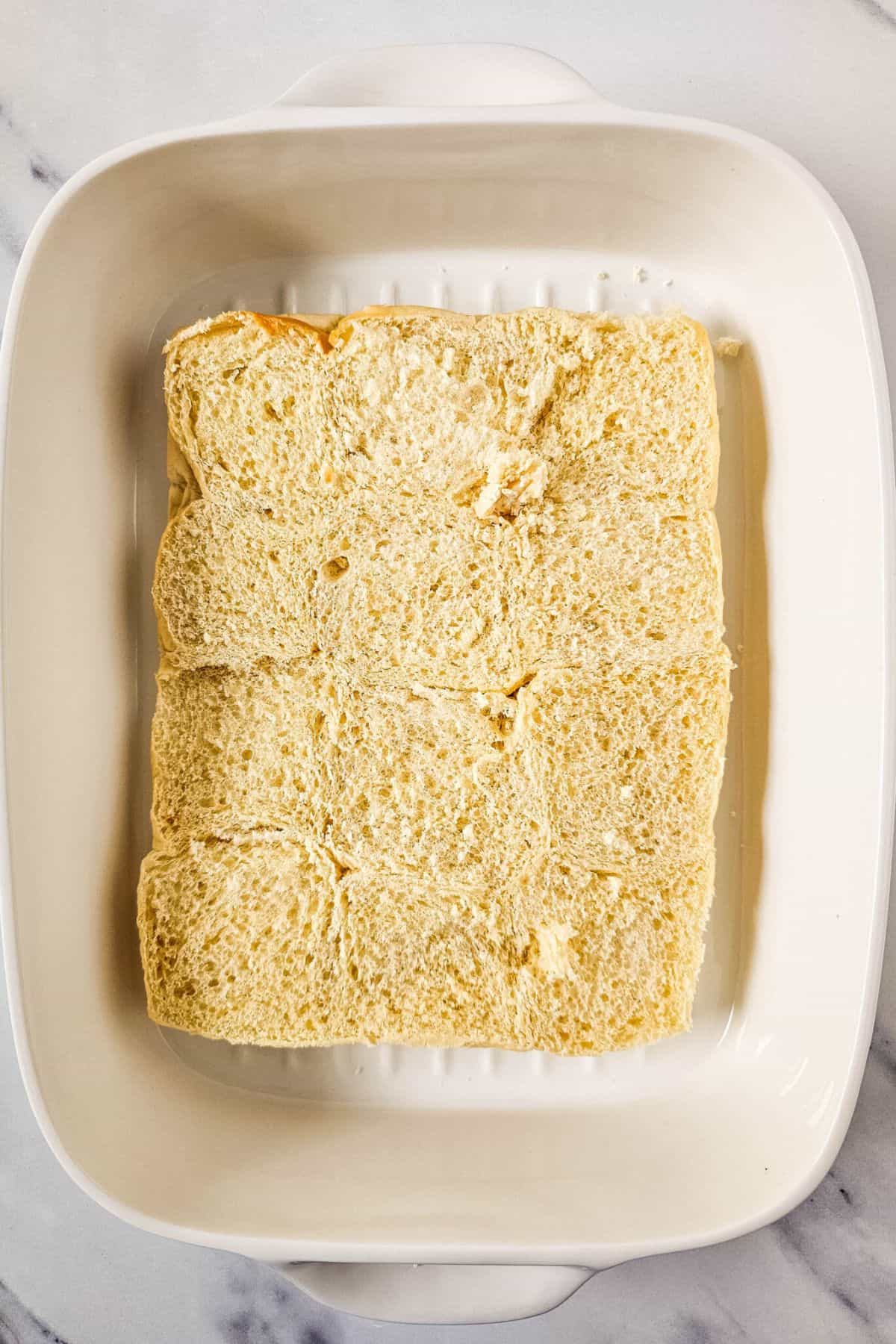 Slider with top bun removed, served in a dish showing the layers inside.