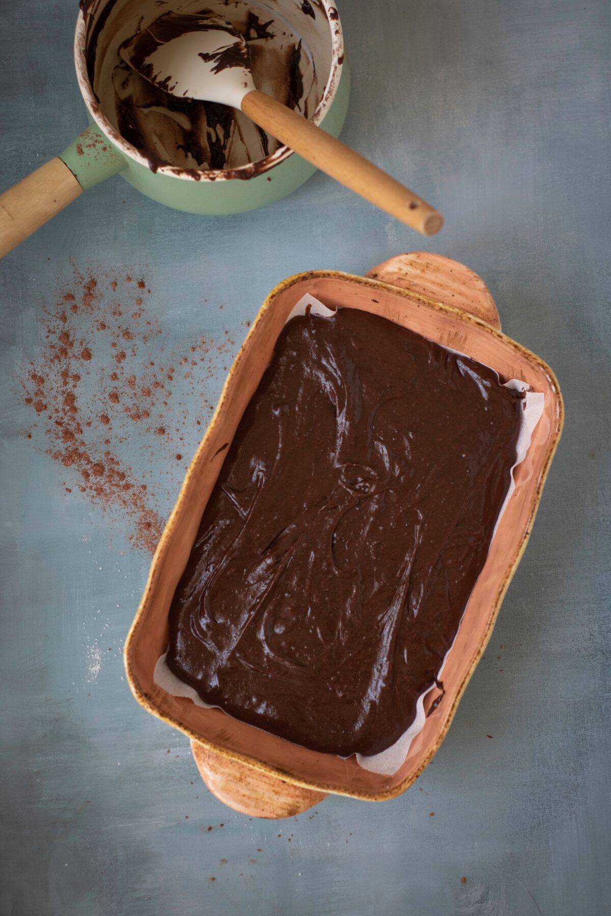 A brownie cake mixture in a rectangular baking pan.