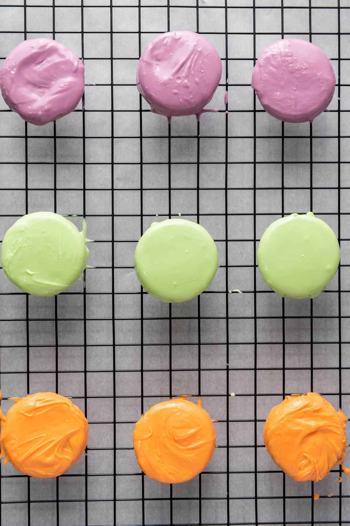 Halloween cookies coated in purple, green, and orange candy melts.