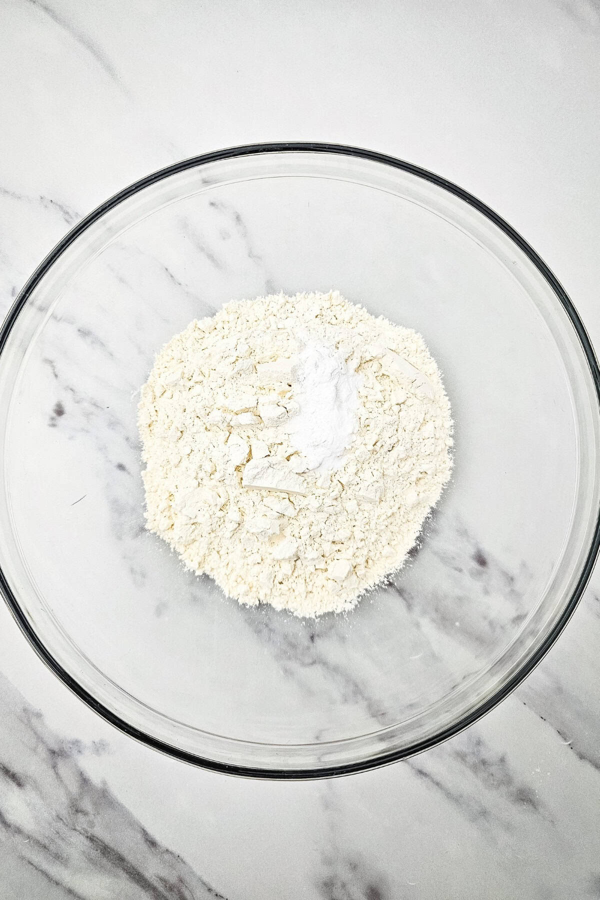 A mixing bowl with dry ingredients.