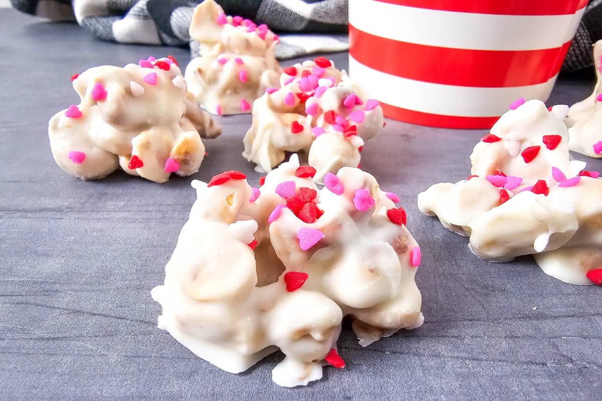 Close-up of white chocolate candies with sprinkles, showing their texture and details.