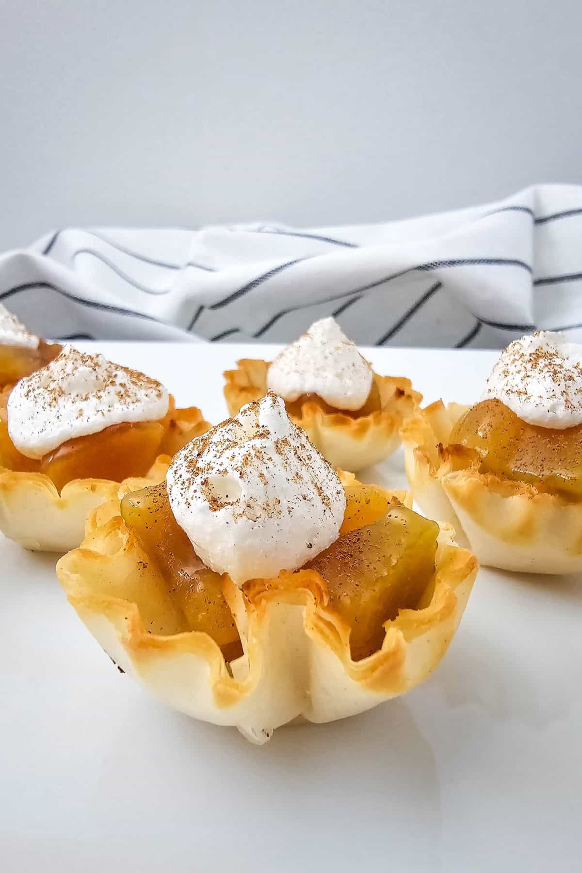 Peaches and Cream Pie Bites being arranged on a serving plate.