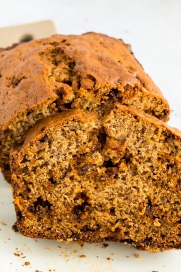 Sliced cinnamon chip banana bread on a cutting board, showing the soft texture and cinnamon chips inside.