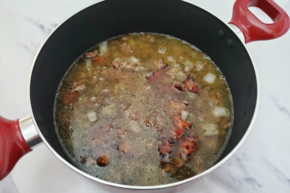 Diced potatoes and ingredients soaking in a pot of water.