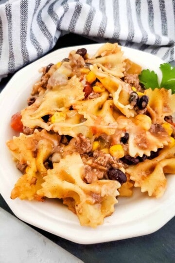 Tex-Mex pasta served on a plate with a cozy cloth background.