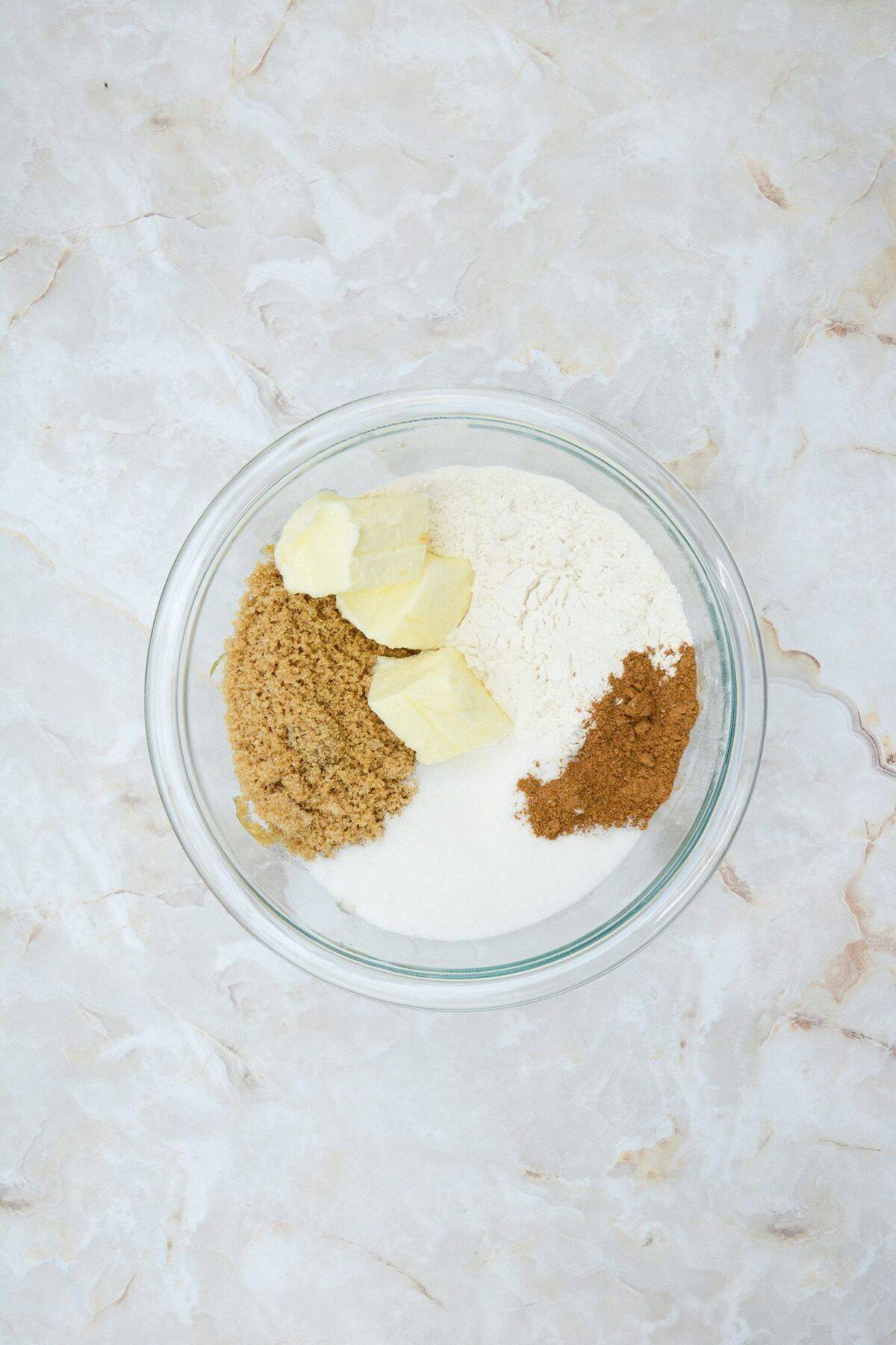 Pumpkin muffin ingredients being mixed together in a large bowl.
