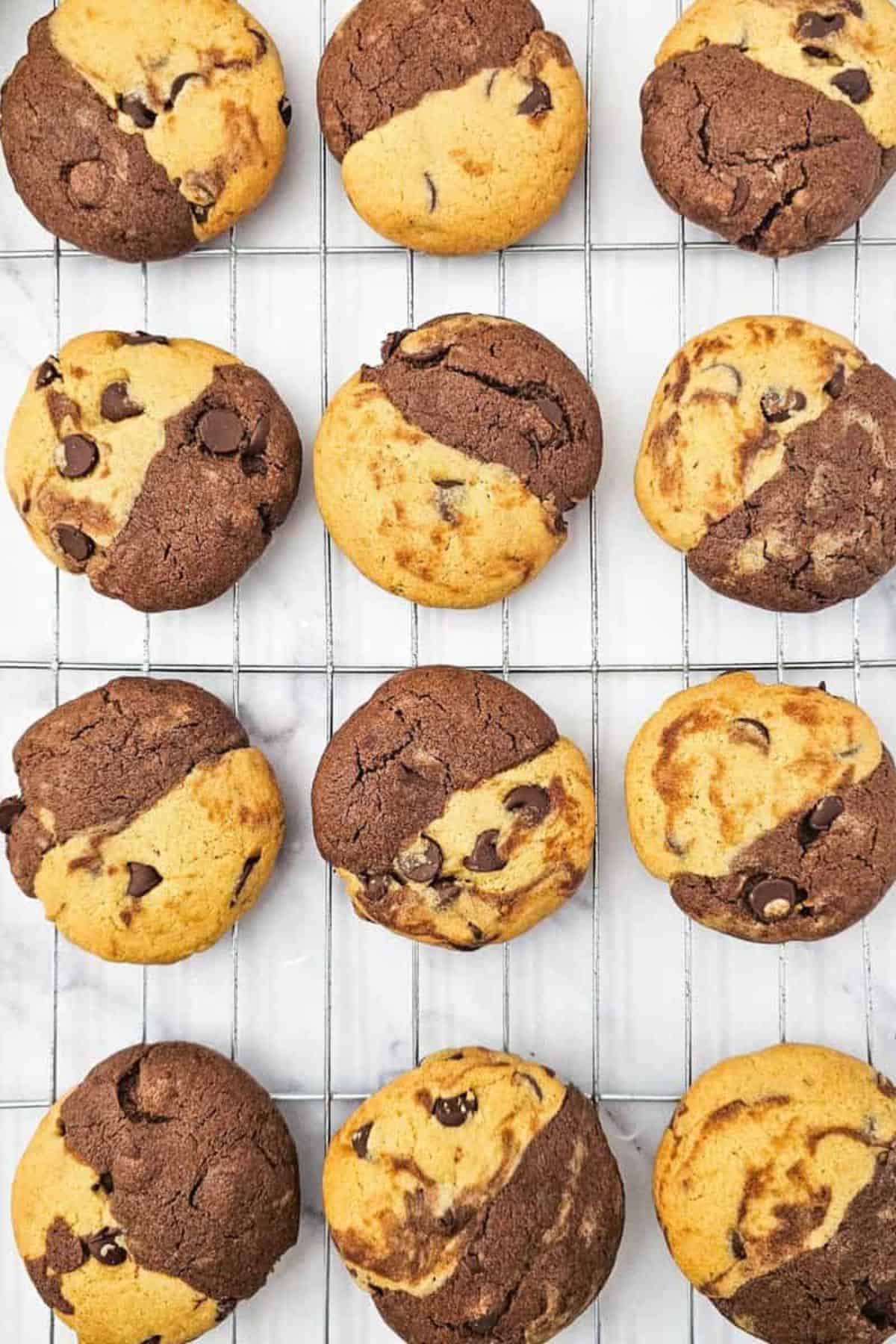 Chocolate chip cookie and brownie hybrid treats arranged in a cooling tray, showing fudgy brownie base and cookie top.