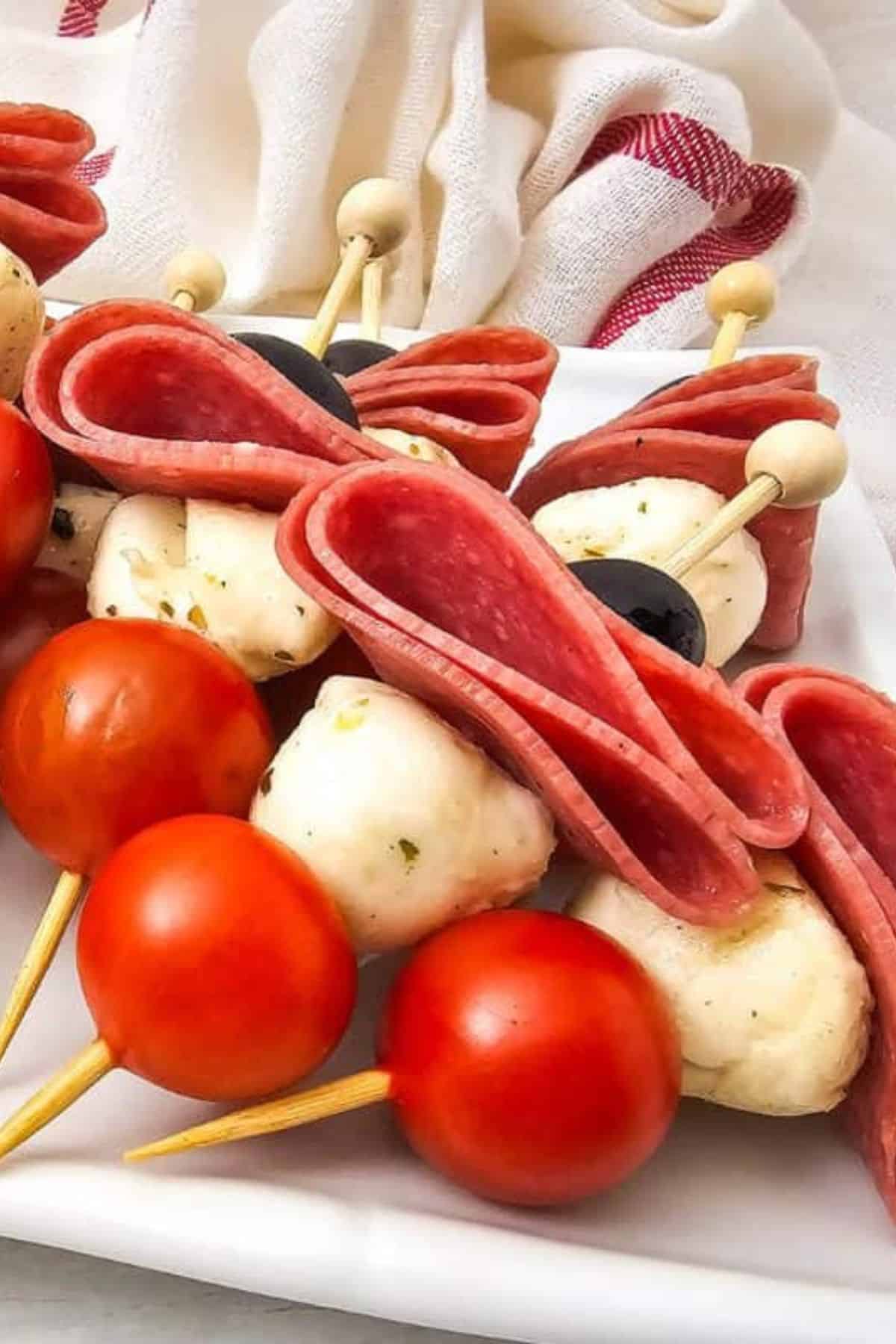 Close-up of antipasto skewers arranged on a plate.