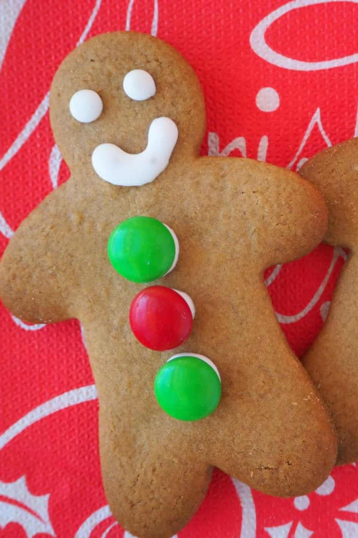 Close-up of a single gingerbread man cookie, showing its spiced, golden-brown texture.