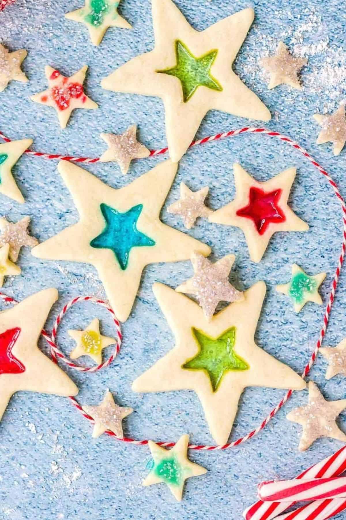 Stained Glass Cookies arranged on a surface, dusted with powdered sugar.