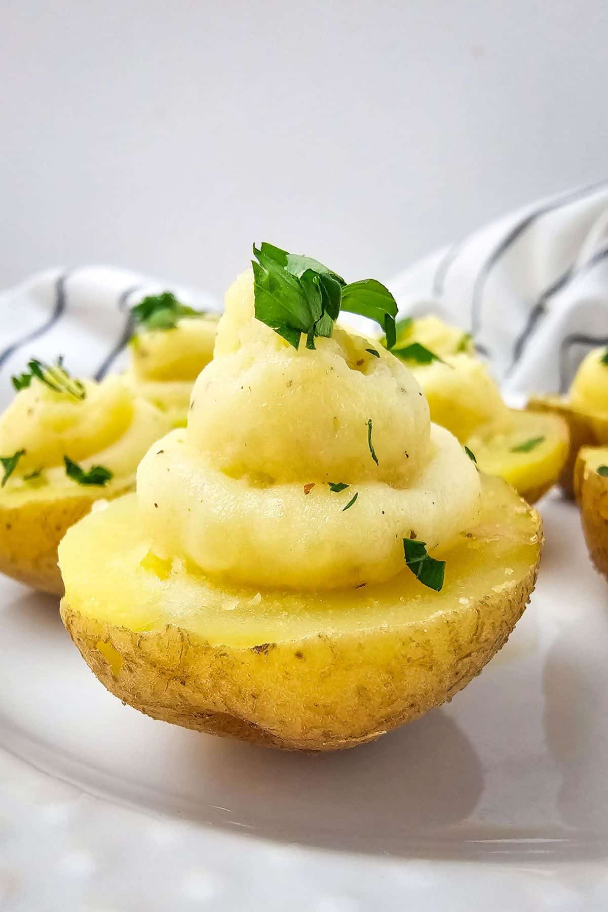 Close-up of deviled potatoes topped with fresh parsley.