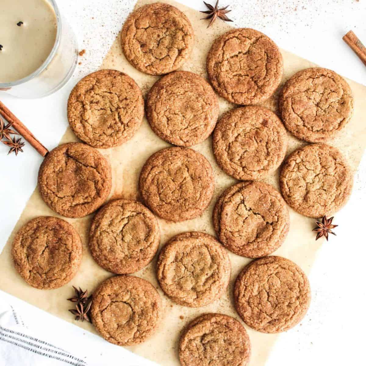 Cookies being flattened and lined up on a wooden board.