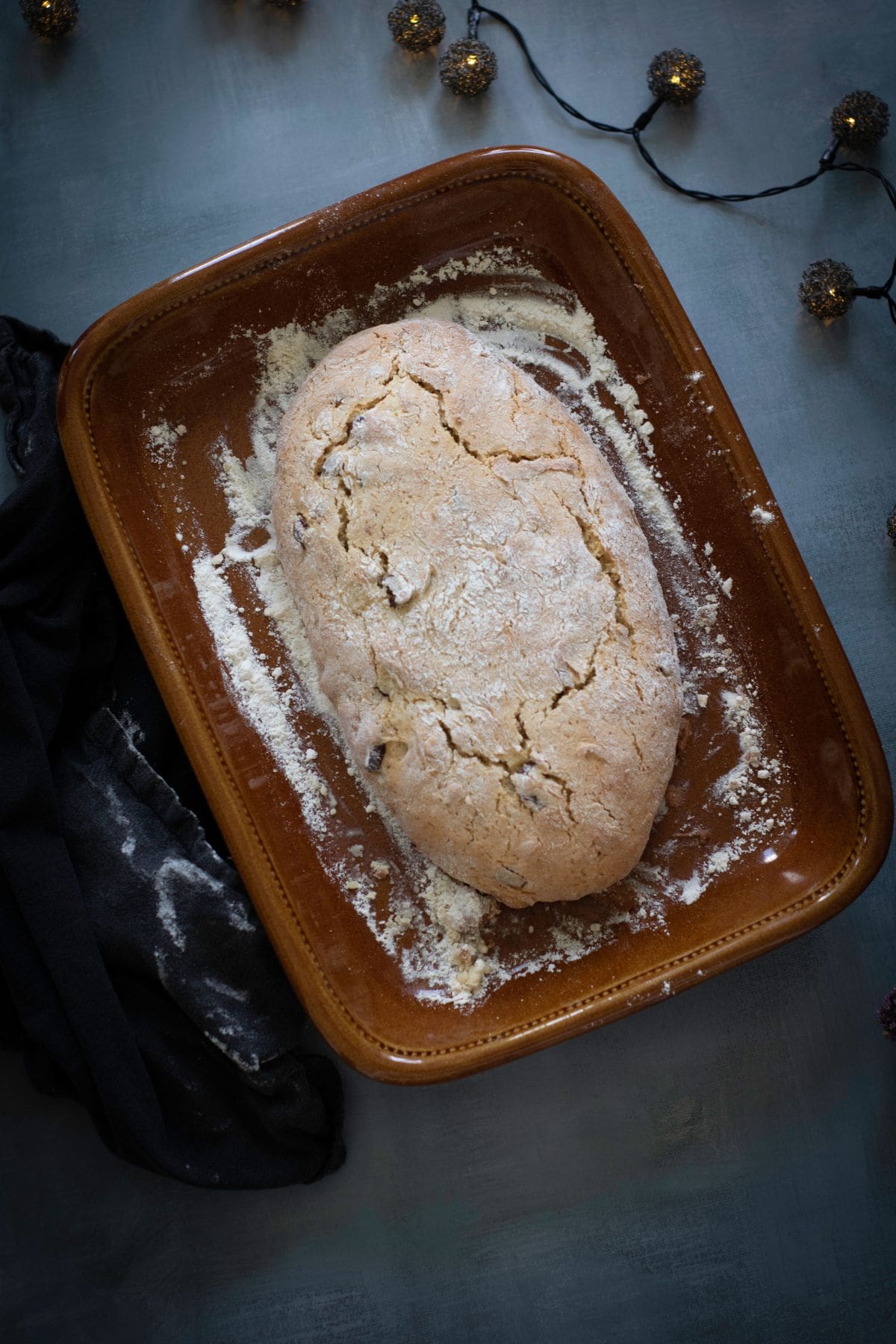 Freshly baked biscotti log resting on a baking sheet after the first bake.