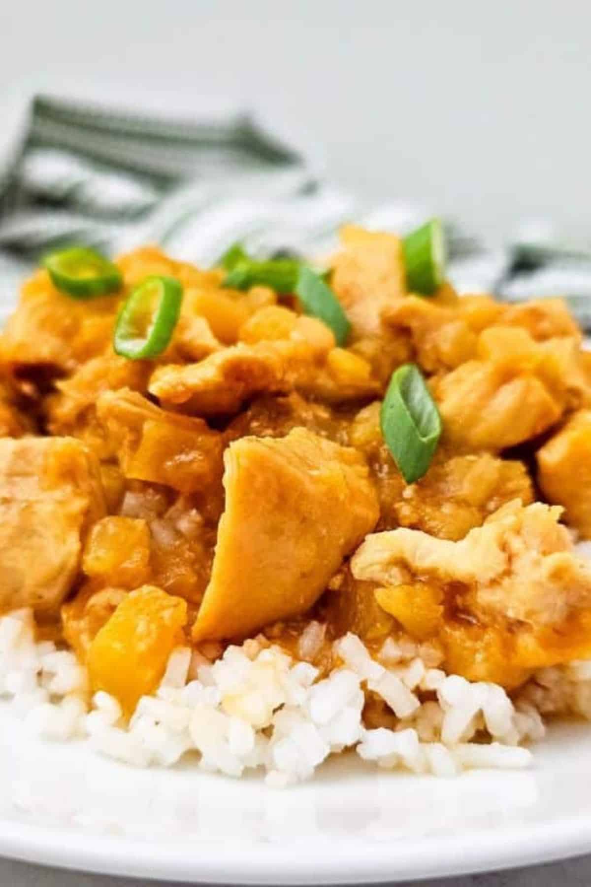 Close-up photo of rice topped with Sweet Crockpot Hawaiian Chicken.