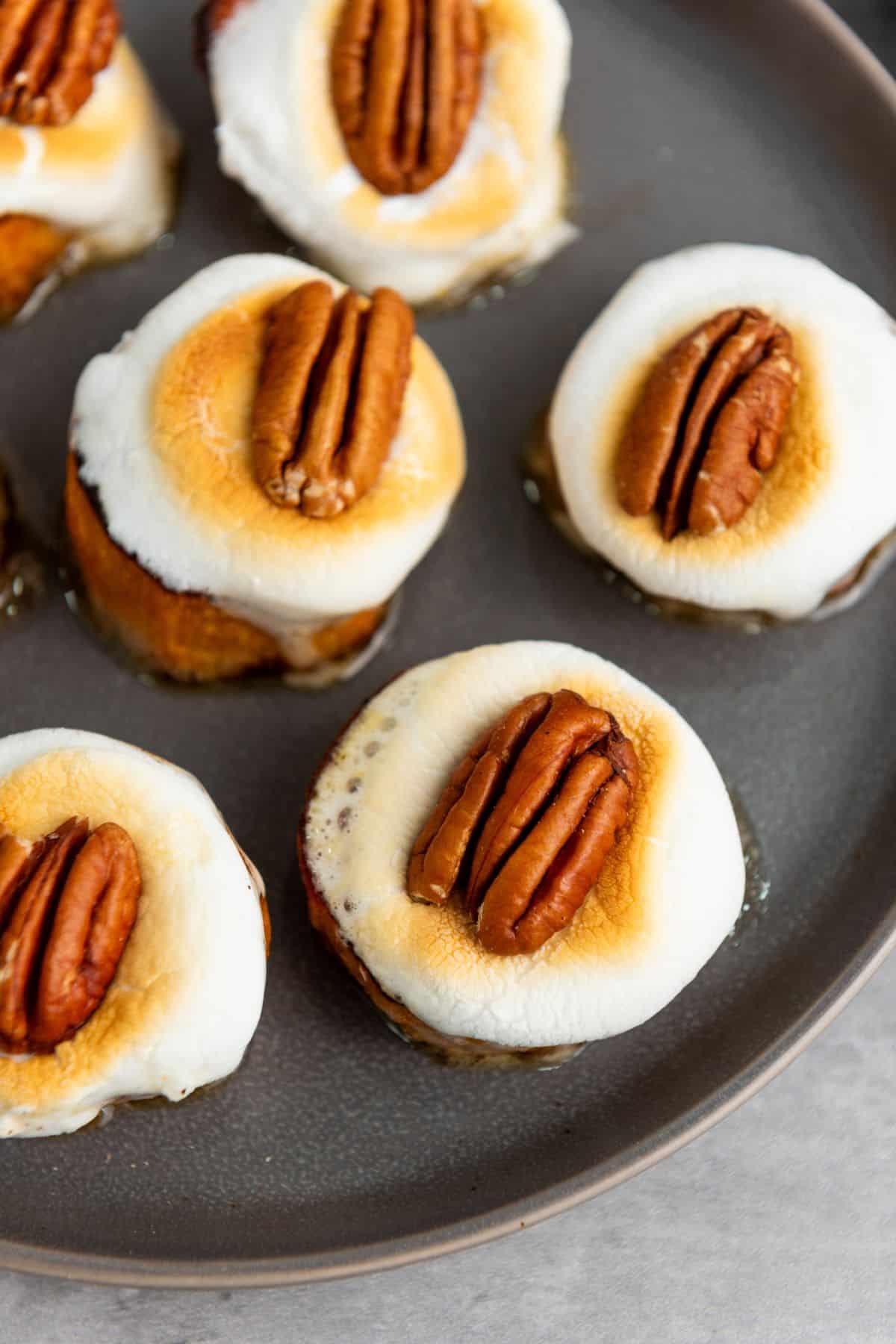 Close-up of golden baked potato bites on a plate, showing crispy edges and a soft, fluffy interior.