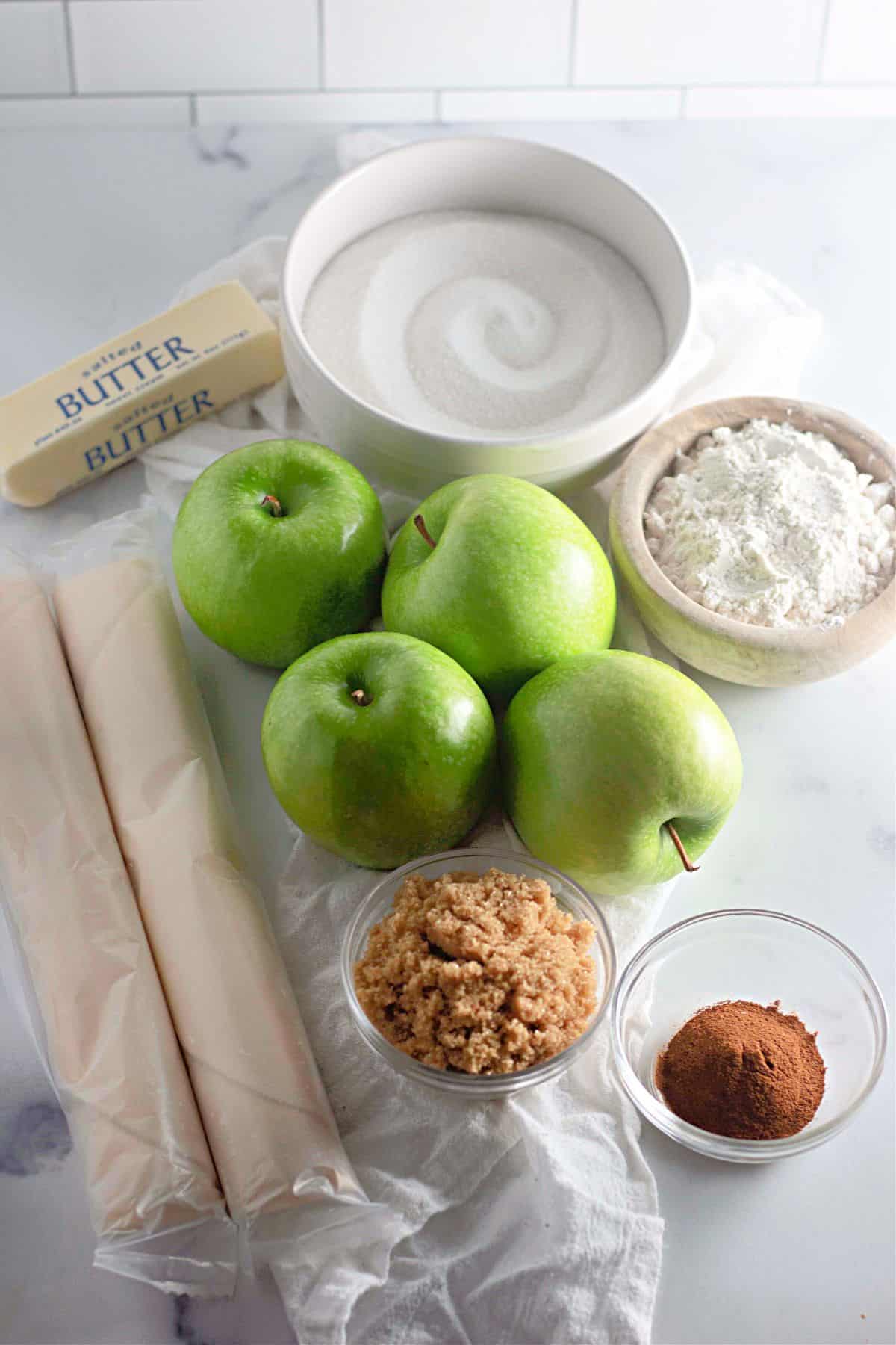 Ingredients for Apple Crumble arranged on a surface.