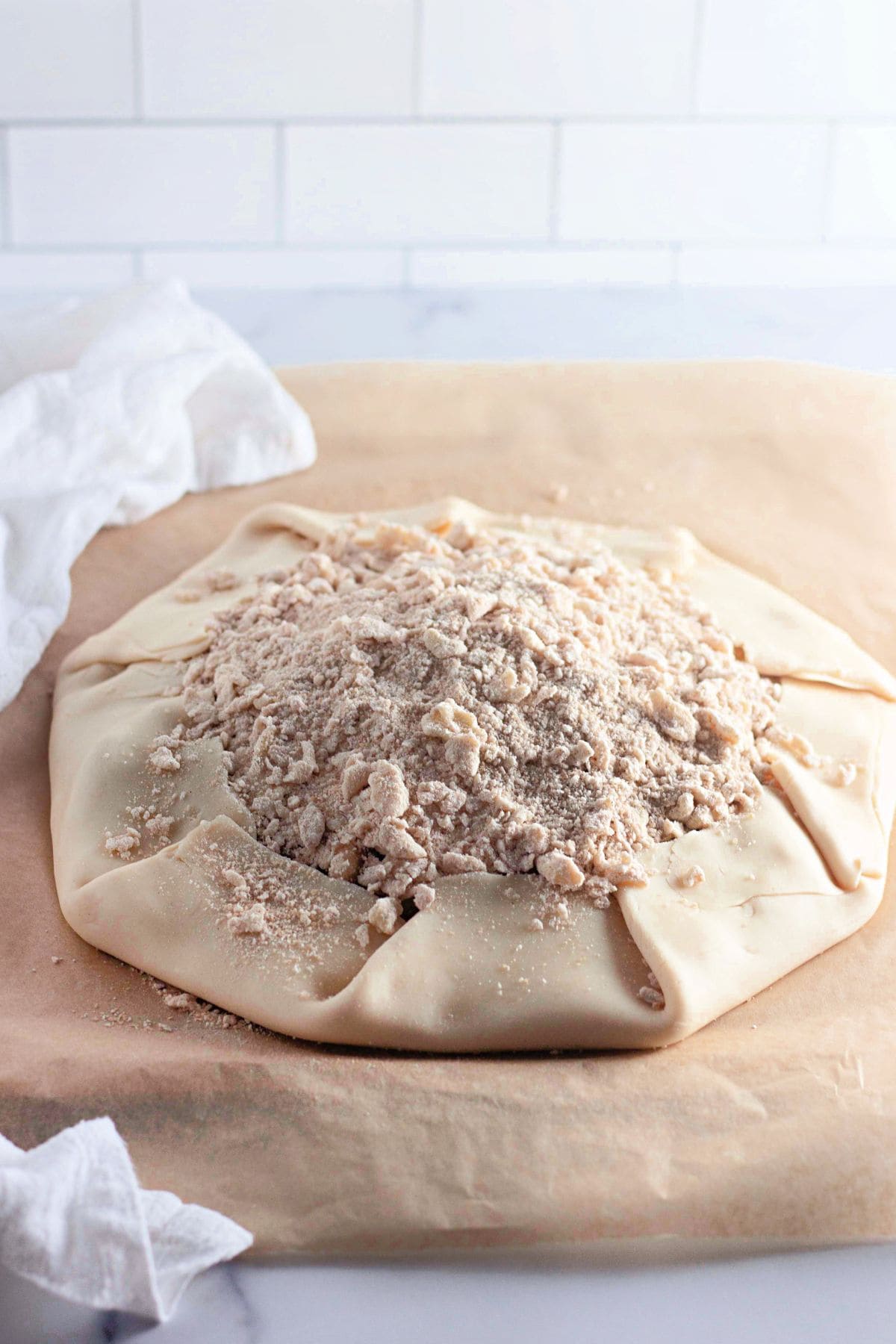 Apple Crumble with topping mixture spread and ready for baking.