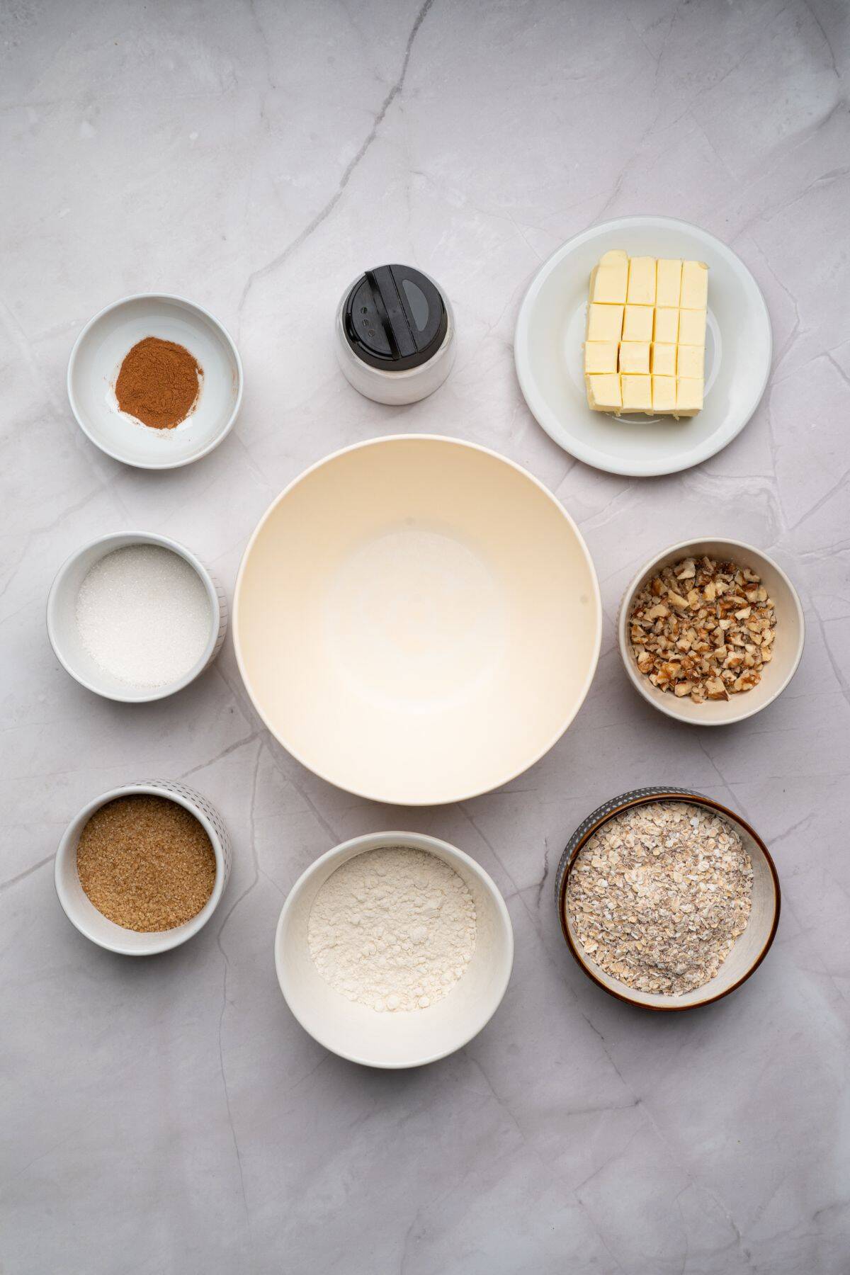 Ingredients for apple crisp laid out on a surface.