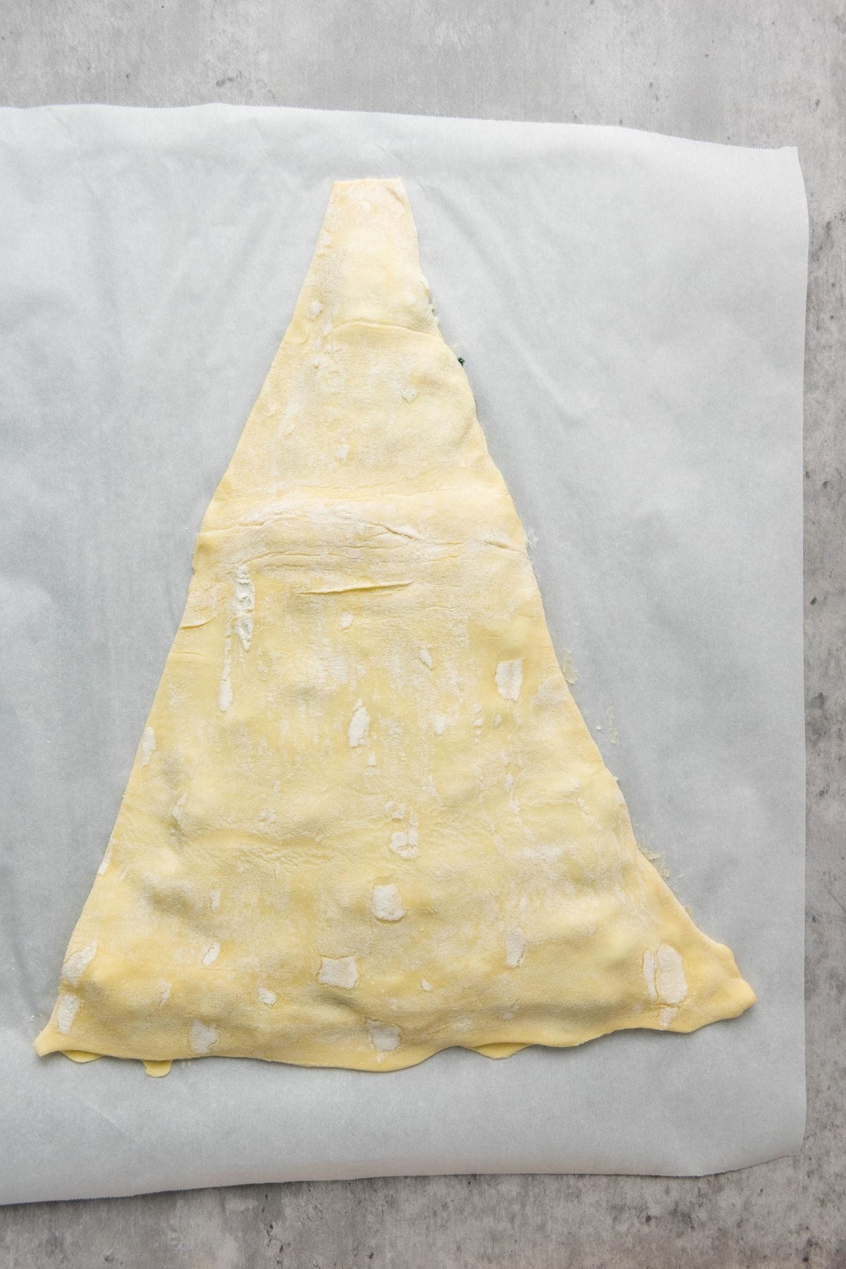 Unbaked spinach dip pastry tree on a flat surface.
