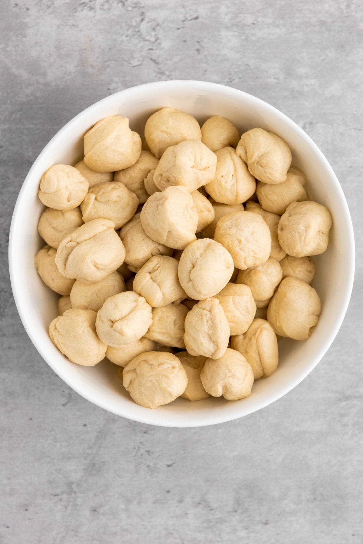 Small pieces of dough placed in a bowl, ready for baking.