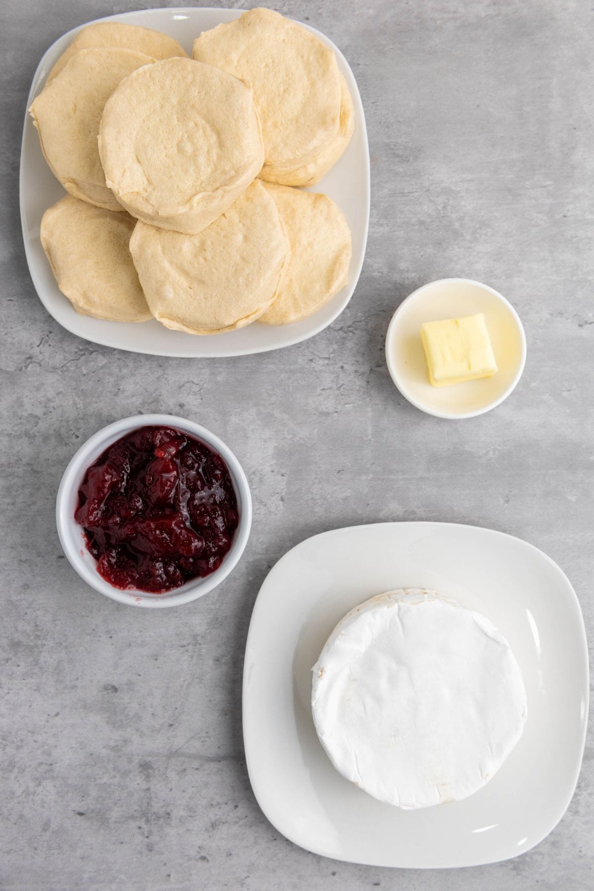Ingredients for Mini Cranberry Brie Pull-Apart Bread displayed on a surface, ready for preparation.