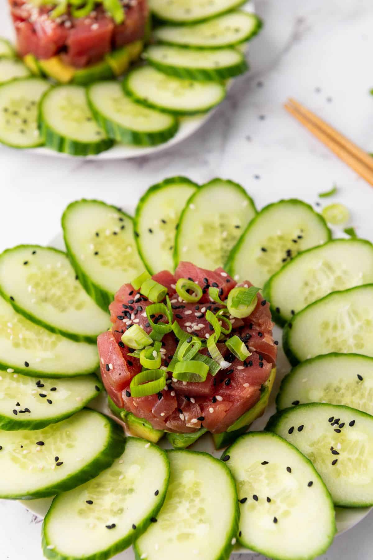 No-cook tuna tartare arranged on a plate and garnished with fresh herbs.