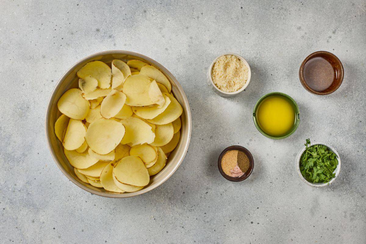 Ingredients for parmesan garlic potato stacks arranged on a countertop, ready for preparation.